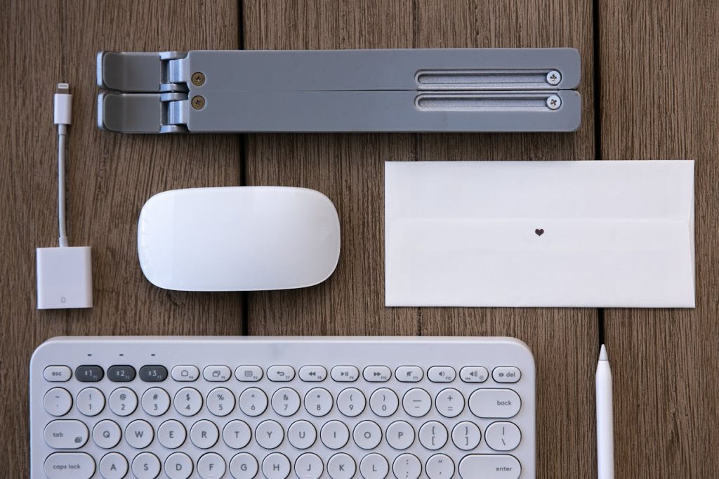 pexels-photo-8250837 Flat lay of modern tech peripherals and stationery on a wooden desk.